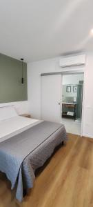 a bedroom with a large bed in a white room at Locazione Turistica Dal Degan 2 in San Bonifacio