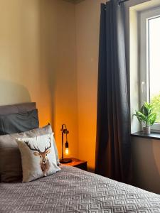a bedroom with a bed with a deer pillow at Hirschquartier in Hachenburg