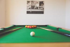 a billiard table with a cue and balls on it at Quoys Self Catering, Shetland in Lerwick