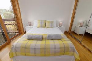 a bedroom with a bed with two pillows on it at Quoys Self Catering, Shetland in Lerwick