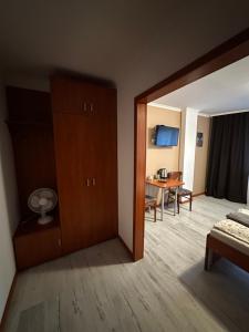 a room with a bedroom with a bed and a table at Bianco - pokoje noclegowe in Częstochowa