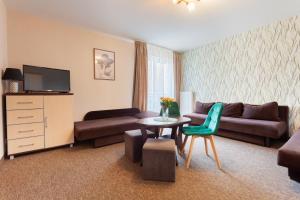 a living room with a couch and a table at Waldi in Grzybowo
