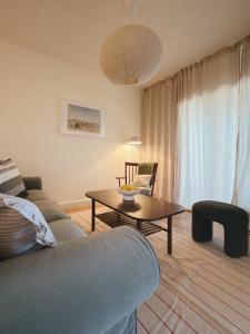 a living room with a couch and a table at Sun Garden House Athens in Nea Makri
