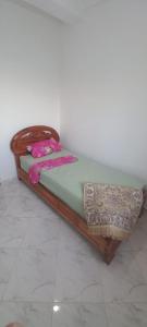a wooden bed sitting in a room at fenêtre de la mère in Al Hoceïma