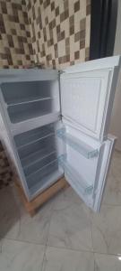an empty refrigerator with its door open in a kitchen at fenêtre de la mère in Al Hoceïma