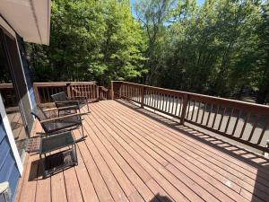 a wooden deck with chairs on a house at Big St Germain Hideaway in Sayner