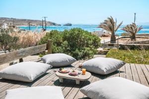 a patio with pillows and a table with a tray of food at Baba Houlakia in Houlakia
