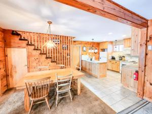 a kitchen and dining room with a wooden table and chairs at Oma's House in Warren