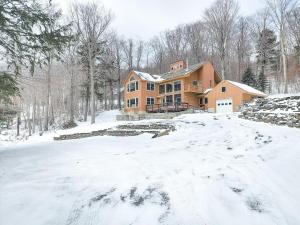 a large house in the snow with a driveway at Oma's House in Warren