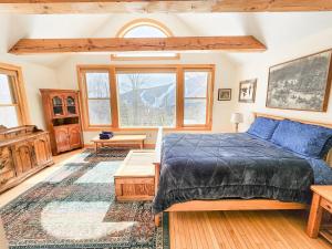 a bedroom with a bed and a large window at Oma's House in Warren