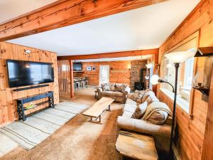 a living room with a couch and a tv at Oma's House in Warren