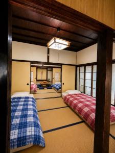 a room with two bunk beds in a room at Guesthouse今井邸 in Tonami
