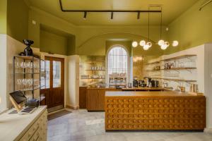 a large kitchen with green walls and a large counter at Koruna Hotel in Prague +123 photos