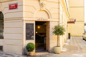 a building with a sign on the door of a restaurant at Koruna Hotel in Prague