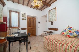 a hotel room with a bed and a table and a dining room at Autenticum Agriturismo Tolfa in Tolfa