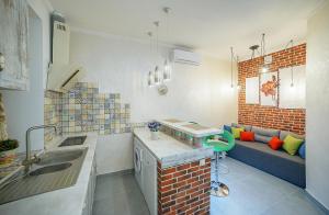 a kitchen with a sink and a couch in a room at Apartment at Lyulki in Lviv