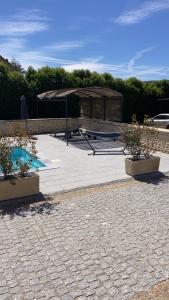 a patio with two potted plants and a building at Gîte chez l'habitant indépendant "La villa des ocres" in Gargas