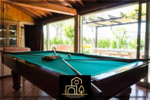 a pool table in the middle of a room at Casa do Alpendre in Arco de Baúlhe