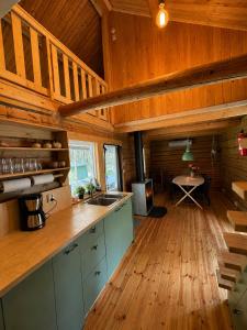 a kitchen with a counter and a table in a room at Cabin in the Woods in Malung +12 photos