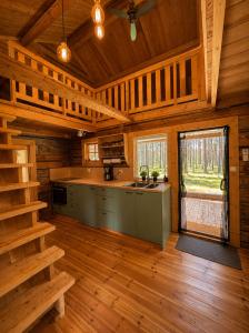 a kitchen in a log cabin with a large window at Cabin in the Woods in Malung
