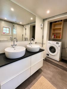two sinks in a bathroom with a washing machine at Cabin in the Woods in Malung