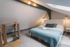 a bedroom with a bed in a attic at Le Cottage Bleu- In the Heart of Riquewihr by La Maison Bleue in Riquewihr