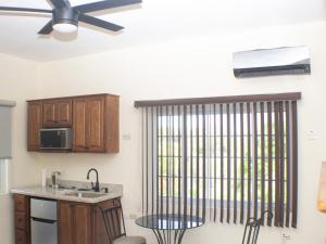 a kitchen with a ceiling fan and a table at The Vista Inn Studio #3 in Falmouth