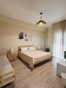 a bedroom with a large bed and a chandelier at Favola Guesthouse Affittacamere in Nettuno +43 photos