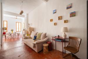 a living room with a couch and a table at Joli Cocon - Meublé de tourisme classé 2 étoiles - Terrasse - Parking in La Ciotat