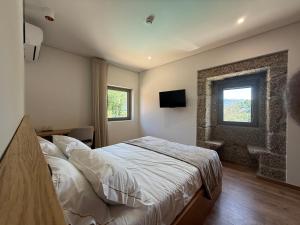 a bedroom with a bed and a window at Villa Lijó Suites in Rio Caldo +75 photos