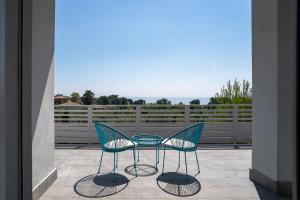 two chairs and a table on a patio at Venti del Garda in Montinelle