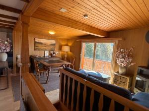 a living room with a couch and a table at Chalet Montana mit Bergblick in Brunig