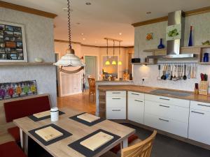 a kitchen with a table and a dining room at Kleine Weite-Das Schwedenhus in Landesbergen