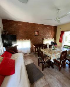 a living room with a table and a dining room at Amanecer y Canela in Mina Clavero