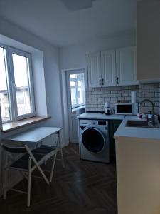 a kitchen with a stove and a sink and a dishwasher at Ultracentral Mangalia seaside exclusive in Mangalia