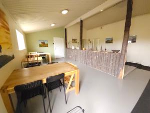 a room with a table and chairs and a bar at Kaldbakur Guesthouse in Heimaland