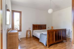 a bedroom with a bed and a wooden dresser at Casa Vacanza 2 Mari in Alghero