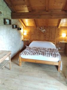 a bedroom with a bed in a wooden room at Chalet Indépendant " L'anfian-ne" in Les Contamines-Montjoie