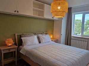 a bedroom with a bed with white pillows and a window at Ultracentral Mangalia seaside exclusive in Mangalia