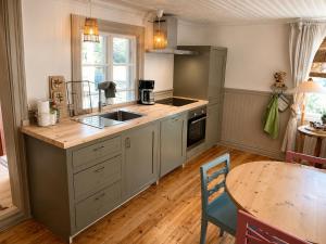a kitchen with a sink and a table and a counter at HomeSweetSweden in Malung
