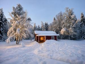 a small house covered in snow in a forest at HomeSweetSweden in Malung +13 photos