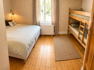 a bedroom with a bunk bed next to a window at HomeSweetSweden in Malung