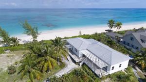an aerial view of a house on the beach at Eleuthera Retreat - Private Villa & Cottages on pink sand beachfront in North Palmetto Point