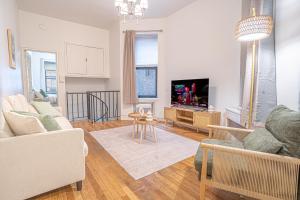 a living room with a couch and a tv at Charm 2Bd in Upper East Side with Backyard in New York
