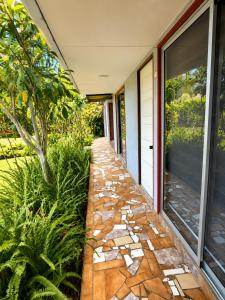 a stone walkway next to a house at Cabañas Anariki in Hanga Roa