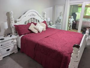 a bedroom with a white bed with a pink comforter at Golf, Hot tub, Arcade, Poker Table, Wildlife, Internet, Pet Friendly, Name-May the Course Be With You in Ellijay