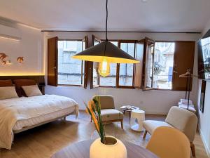 a bedroom with a bed and a living room at YourHouse O Foxo in Allariz