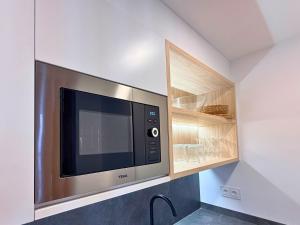 a microwave oven in a kitchen with a cabinet at YourHouse O Foxo in Allariz