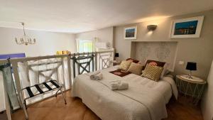 a bedroom with a bed with two stuffed animals on it at Entre vignes et dentelles in Courthézon