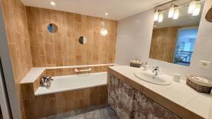 a bathroom with a tub and a sink at Entre vignes et dentelles in Courthézon +71 photos
